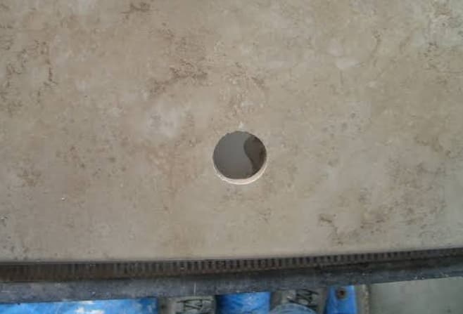 Smooth edges of drilled holes in tile